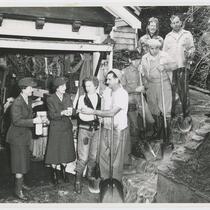 Women bring refreshments to men with shovels during flood, Beverly Glen, Los Angeles, 1952