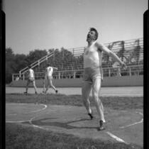 Alma Richards engaged in a discus throw, circa 1912-1920