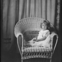 Carolyn Bartlett in wicker chair, Santa Monica, circa 1923