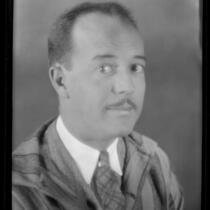 Portrait of Darrel B. Foss, in suit, tie, and striped overcoat, 1924