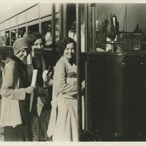 Three young women boarding a bus