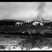 Distant view of baseball game with campus in background, 1946