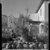 Woman and man in rock garden, El Mirador Hotel, Palm Springs, 1935
