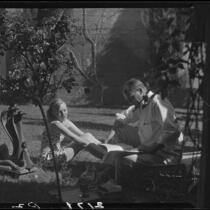 R. Lee Miller and Mrs. Jack Pfister in a patio, Palm Springs