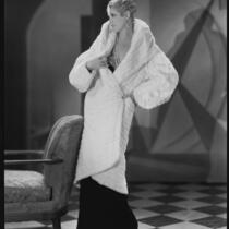 Peggy Hamilton modeling a white ermine coat, 1930