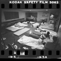 Youths sleeping on mattresses on the floor at Central Juvenile Hall in Los Angeles, Calif., 1983