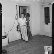 Suspects in the Everett-Stephens murders Charles A. Keefe and Roy Degman entering a room, Los Angeles, 1937