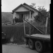 Workmen preparing house to be moved out of Chavez Ravine in Los Angeles, Calif.