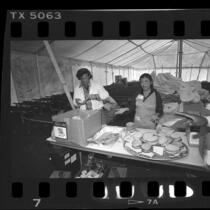 Volunteers making sandwiches for occupants of Tent City II, in Los Angeles, Calif., 1986
