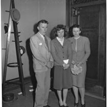 Shirley Smith stands with her mother, Betty Alice Phillips, and father, Melvin David Smith, outside of the courtroom while Superior Judge Fred Miller decides on a home for her after her divorced parents declare they do not want custody, Los Angeles, 1947