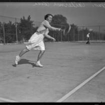 Catherine Rose, Tennis Champion on the Griffith Park tennis team, playing on a court, 1933