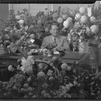 Santa Monica City Hall dedication, city official surrounded by flowers, Santa Monica, 1939