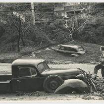 Boy surveys damage during flood, Beverly Glen, Los Angeles, 1952
