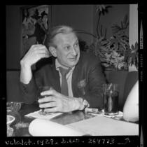 Writer Louis Studs Terkel seated at restaurant table in Los Angeles, Calif., 1970