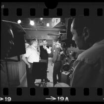 Actor Jack Webb speaking with cinematographer Walter Strenge on the set of "Dragnet '66," in Calif., 1966