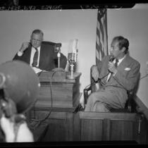 Actor Rex Harrison answering questions from coroner Ira Nance at inquiry on Carol Landis' suicide, Calif., 1948