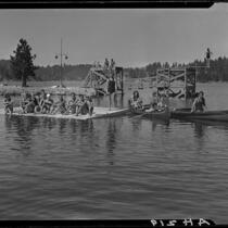 Young people in canoes, on floating dock, and on diving platforms, Lake Arrowhead, 1929