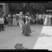 Crowd watching two dancers at the 1945 Los Angeles Filipino Fiesta