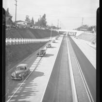 Automobiles travel down Arroyo Seco Parkway at the highway's dedication, 1940.
