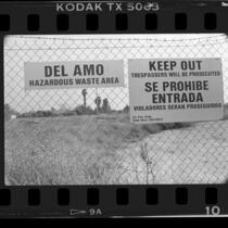 Warning signs on fence at Del Amo hazardous waste site in Los Angeles, Calif., 1986