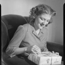 Betty Hanna holding gift, 1941