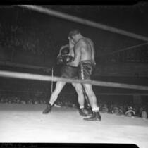 Boxers "Young Stuhley" Stuhlsatz and Gus Lesnevich spar in downtown Los Angeles.  June 22, 1937.