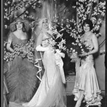 Peggy Hamilton with actresses Priscilla Dean and June Marlowe modeling wedding attire at the Cocoanut Grove, Los Angeles, 1929