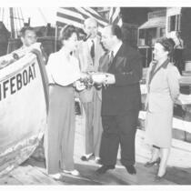 Lifeboat: Alfred Hitchcock handing Tallulah Bankhead bottle for christening as John Steinbeck, MacGowan and Alma Hitchcock watch