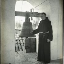 Monk in bell tower with the Great Bell at Mission Santa Barbara, Santa Barbara, 1898