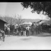 Men standing outside tents in the days following the failure of the Saint Francis Dam and resulting flood, Bardsdale (Calif.), 1928