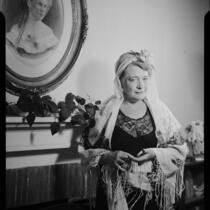 Mrs. Flournoy, in head scarf, lace dress, and shawl, [1950s?]
