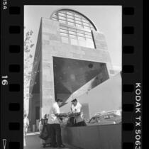 Workman polishing the main entrance sign to MOCA, Los Angeles, 1986