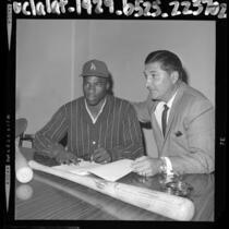 17 years old Willie Crawford, signing his baseball contract with Los Angeles Dodger scout Al Campanis, 1964