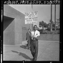 Washington Davis, real estate broker, picketing Los Angeles Hall of Administration in protest against property taxes, 1964