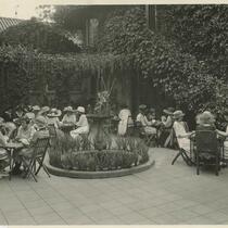 Women gathered by fountain at La Casa de Flores hotel, Los Angeles
