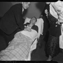 District Attorney Buron Fitts on a stretcher after being shot, Los Angeles, 1937