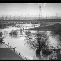 Pacific Electric Railway (or Red Car Trolley) bridge during rainstorm flooding in the Los Angeles River, Los Angeles, 1927