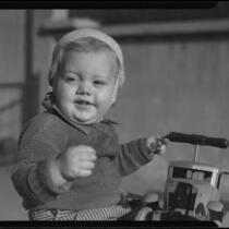 Baby with toy car, Los Angeles, circa 1935
