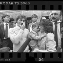 Ryan Thomas and parents outside courthouse after AIDS case verdict, Calif., 1986