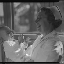 Baby and nurse, Los Angeles, circa 1935