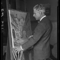 Wilson Silsby in studio, with easel, brush, and painting, Los Angeles, 1927