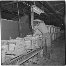 Employee working at the Universal-Rundle ceramic factory, Redlands, 1940s