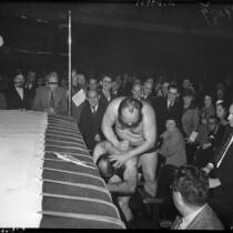 Wrestlers Bluebeard Lewis and Baron Benny Ginsberg grapple outside the ring, May 26, 1937