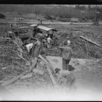 Workers using tractors to clear flood debris after the flood resulting from the failure of the Saint Francis Dam, Santa Clara River Valley (Calif.), 1928