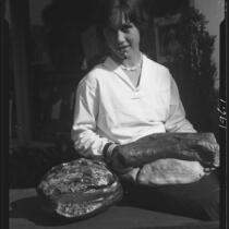 Woman with petrified wood, Palos Verdes Estates, 1930 or 1931