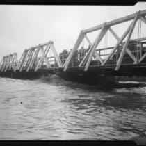 Center street bridge spanning the San Gabriel River swollen with rainstorm flooding, Los Angeles County, 1927