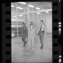 Charles Manson, escorted by two Los Angeles Sheriffs, 1973