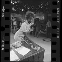 NBC's Studio 9 janitress, Anita Taylor dusting during filming of "Days of Our Lives" in Burbank, Calif., 1972