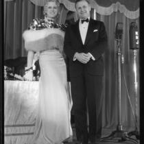 Peggy Hamilton, wearing a currency-themed gown, with James Francis Thaddeus O'Connor, Comptroller of the Currency, at Grauman's Theater, Los Angeles, 1932