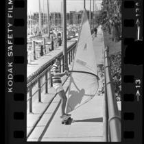 Hans Dose wind surfing on skateboard at Long Beach Marina, Calif., 1978